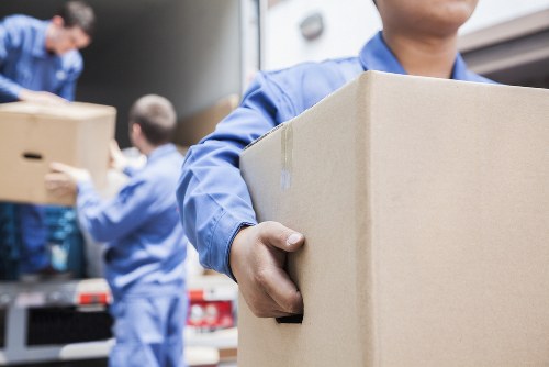 Professional removal team loading furniture for a Watford home move