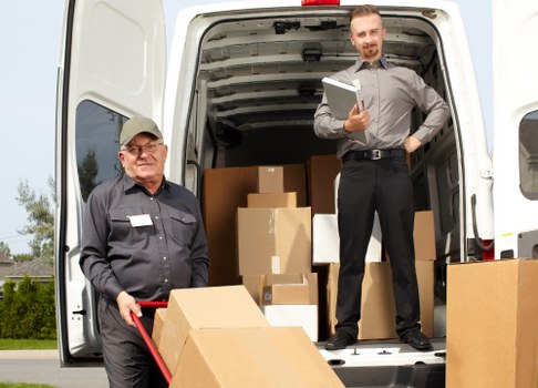 Man with van loading items into a vehicle for a UK removals service