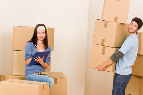 Local movers handling furniture in a Watford street