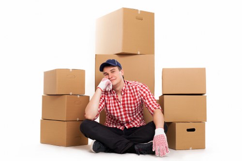 Worker using safe manual handling near stairs and doorways